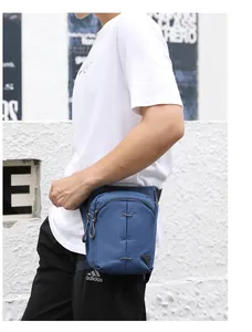 Detail of dark blue tactical leg bag with adjustable straps on a male model in action
