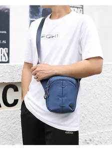 Detail of dark blue outdoor crossbody bag featuring durable nylon fabric and elastic cords