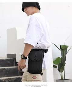 Detail of waterproof matte black tactical leg bag with adjustable straps and multiple zippers
