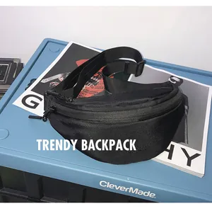 Top view of a trendy black ballistic nylon crossbody bag styled with magazines and a blue bin