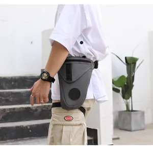 Detailed view of grey tactical drop leg bag worn on waist with adjustable buckles and straps