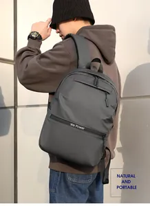 Close-up of waterproof dark grey backpack with multiple zippers and wide padded straps