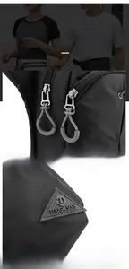 Detail of durable nylon fabric texture and metal zipper pullers on outdoor leg bag