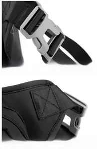 Detail of durable plastic buckle and reinforced cross-stitching on black tactical leg bag