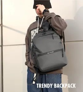 Outdoor view of a dark grey waterproof business backpack with We Power logo