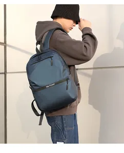 Detail of waterproof navy blue backpack with We Power slogan and matte nylon texture