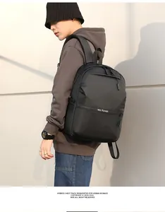 Side view of male model wearing a sleek black waterproof business backpack with side pockets