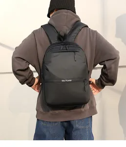 Outdoor shot of a black water-resistant backpack with wide ergonomic shoulder straps