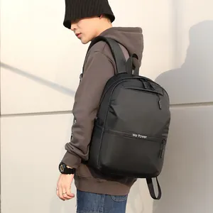 Waterproof black business laptop backpack with 'We Power' logo for men on grey background