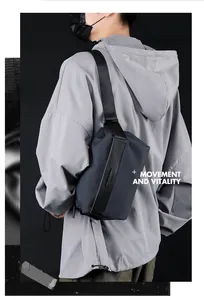 Detail of waterproof nylon crossbody bag with leather trim and wide shoulder strap