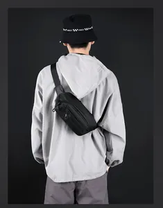 Rear view of black nylon sports chest bag with LYW POWER logo on grey hoodie model