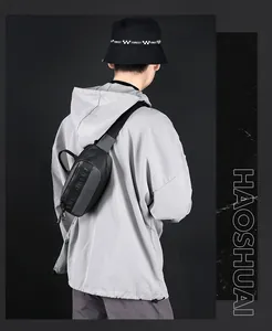 Waterproof black crossbody chest bag shown on model with WE POWER lettering detail