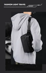 Rear view of a man wearing a sleek black waterproof crossbody bag with adjustable strap