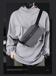 Close-up of waterproof grey nylon tech crossbody bag showing multi-layer storage detail