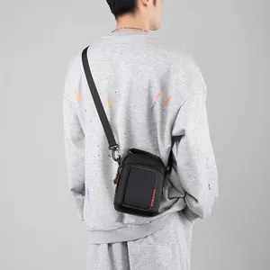 Men's black mini crossbody bag with orange WEPOWER logo and nylon shoulder strap