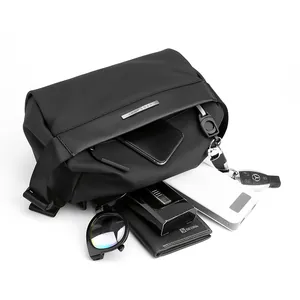Waterproof black functional crossbody bag showing spacious interior and daily essentials