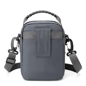 Dark gray waterproof nylon crossbody bag and waist pack with ergonomic top handle