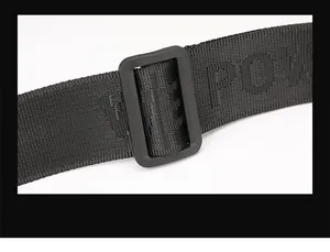 Detail of adjustable nylon strap with FEEL POWER lettering and matte plastic buckle
