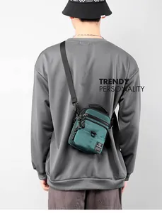 Rear view of a model wearing the waterproof nylon crossbody bag with adjustable strap
