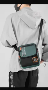 Close-up of military-style crossbody bag with multi-zipper layers and durable nylon fabric