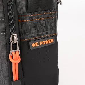 Waterproof black nylon crossbody bag for men featuring stylish orange zip pulls and logo detail