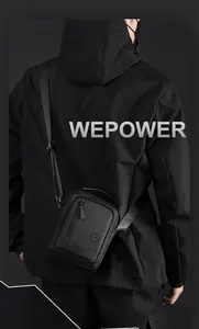Detail of adjustable padded shoulder strap with embossed logo on black techwear crossbody bag