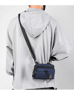 Rear view of a dark blue multifunctional crossbody bag with adjustable nylon strap for men
