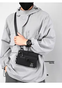 Detailed view of black nylon crossbody bag with multi-zipper pockets and adjustable strap