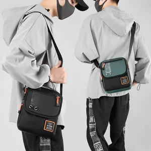 Men's tactical crossbody bag in black and olive green featuring heavy-duty nylon fabric