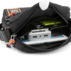 Men's black nylon tactical crossbody bag with spacious compartments and orange zipper pulls