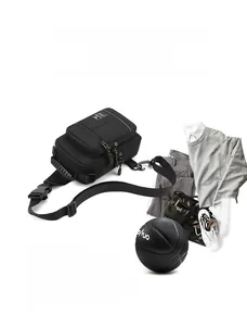 Detail view of black functional nylon chest bag with multiple zipper compartments and buckles