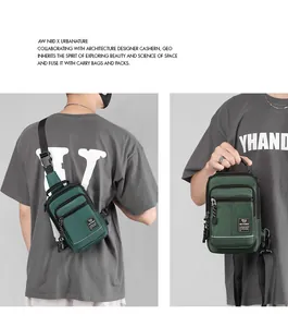 Detail of dark green nylon chest bag with reflective safety strip and zippers