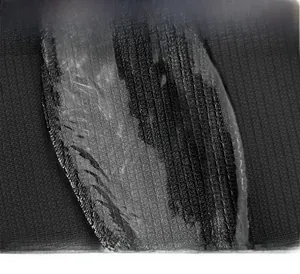 Macro shot of durable nylon fabric texture and branded logo detail on a men's chest bag
