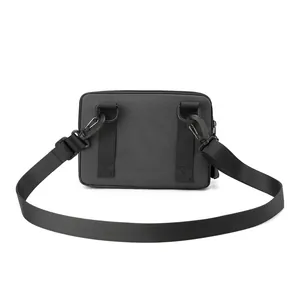 Rear view of black nylon crossbody bag with adjustable strap and reinforced D-rings