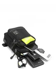 Detail view of black nylon chest bag with USB port showing interior storage capacity