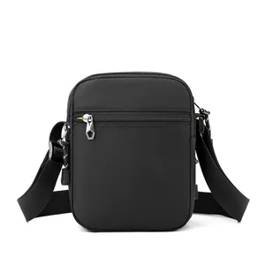 Mini nylon crossbody bag for men featuring adjustable strap and geometric metal zippers