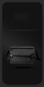 Macro detail of black waterproof messenger bag with dual buckles and woven brand logo