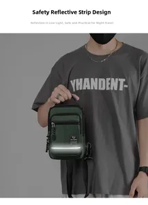Detail of army green nylon crossbody bag showing the reflective safety strip and top handle