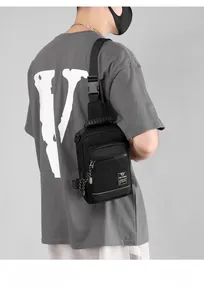 Detailed view of black nylon tactical chest bag with multi-pocket design and strap