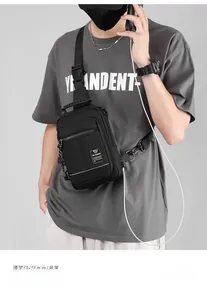 Detail of black nylon men's sling bag showing USB charging port and zipper compartments