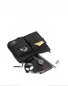 Detailed view of black nylon crossbody bag showing compartments for phone and daily items