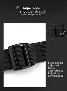 Detail of adjustable woven shoulder strap and metal buckle on black nylon crossbody bag