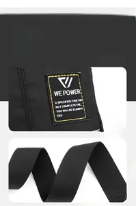 Detail of woven logo tag and durable nylon shoulder strap on black men crossbody bag