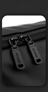 Detailed macro view of the durable dual-zipper closure on a black outdoor messenger bag