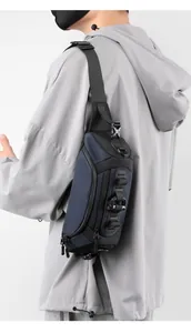Detail of navy ballistic nylon tactical sling bag with MOLLE webbing and buckles