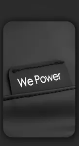 Close-up of We Power brand label on black minimalist matte finish messenger bag