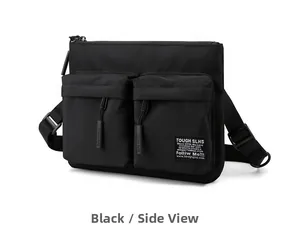Close-up of black tactical crossbody bag with dual zippered pockets and adjustable strap