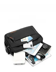 Detailed view of the black crossbody bag with multiple compartments and high storage capacity