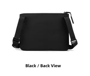 Back view of a minimalist black nylon crossbody bag with adjustable fabric shoulder strap