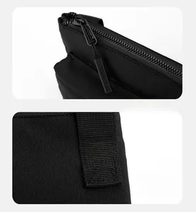Detail of durable black cross-stitching on strap and smooth metal zipper with engraving